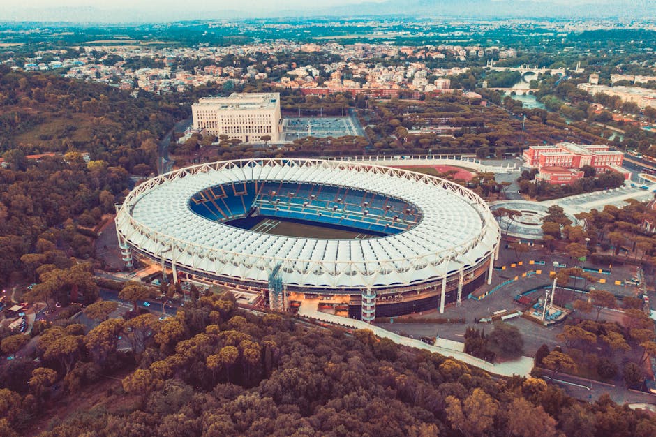 A stunning aerial image showcasing the iconic Stadio Olimpico surrounded by lush greenery in Rome, Italy.